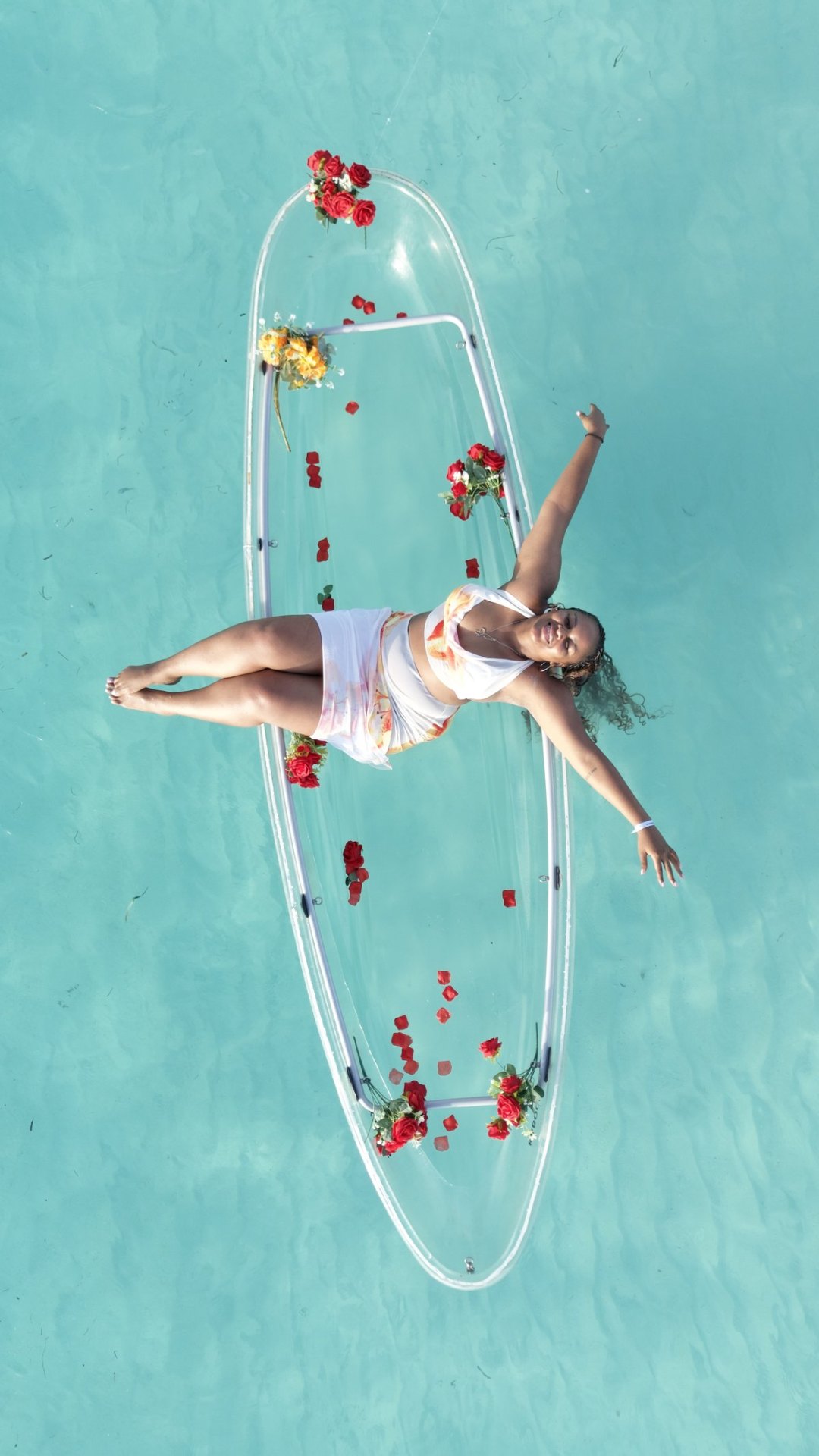 Clear kayak with red roses aerial view