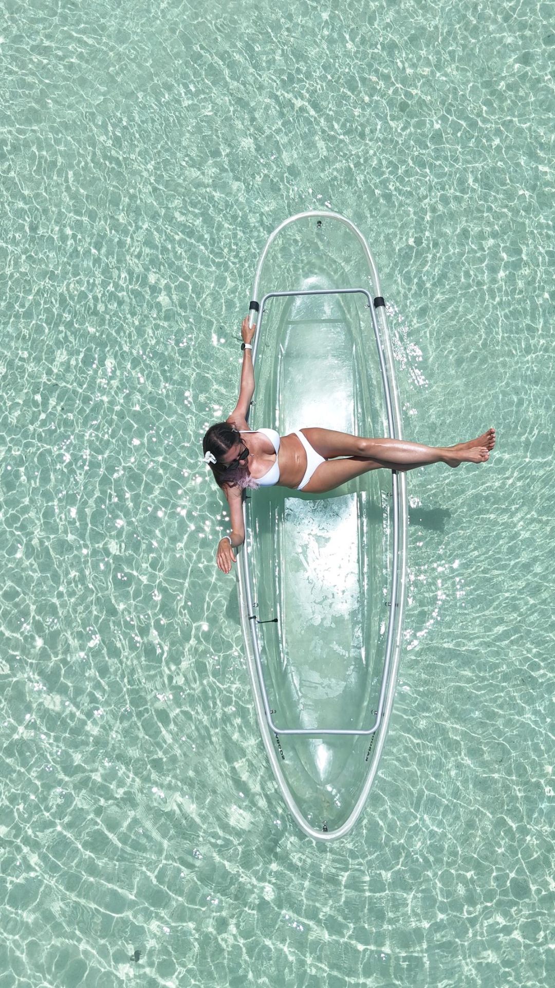 Aerial view of a clear kayak on turquoise water