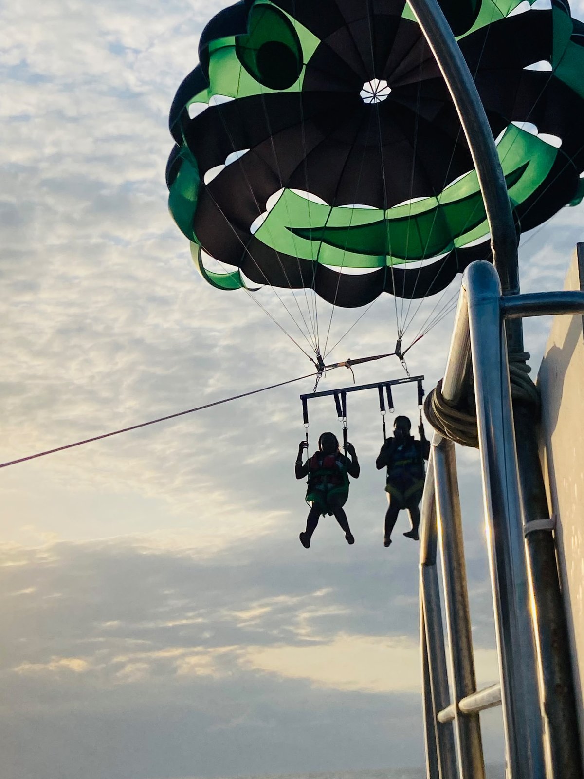 Tandem parasail lifting off from the boat